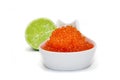 Red caviar spoon and unfocused lime Royalty Free Stock Photo