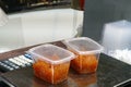 Red caviar in transparent containers stand on scales on market