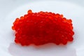 red caviar on a white plate salted