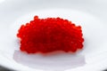 red caviar on a white plate salted