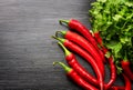 Red cayenne peppers Capsicum annuum and verdure on wooden table. Top view. Royalty Free Stock Photo