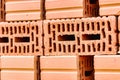 Red ceramic bricks at the construction site. Keramoblock. Hollow brick. Construction of a red brick building. Close-up. Material Royalty Free Stock Photo