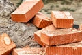 Red ceramic bricks at the construction site. Keramoblock. Hollow brick. Construction of a red brick building. Close-up. Material Royalty Free Stock Photo