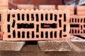 Red ceramic bricks at the construction site. Keramoblock. Hollow brick. Construction of a red brick building. Close-up. Material Royalty Free Stock Photo