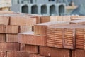 Red ceramic bricks stacked on a construction site. Construction Materials. Red brick for building a house Royalty Free Stock Photo