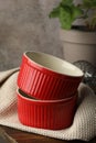 Red ceramic casseroles on wooden table, closeup Royalty Free Stock Photo