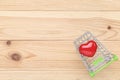 Red ceramic heart with shopping cart Royalty Free Stock Photo