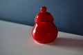 Red ceramic milk jug on blue background Royalty Free Stock Photo