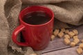 A red ceramic mug of tea and chunks of brown cane sugar. Close up Royalty Free Stock Photo