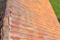 A red ceramic roof tile placed on an old building, photos taken up close. Royalty Free Stock Photo