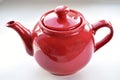 Red ceramic teapot on white background Royalty Free Stock Photo