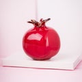 Red ceramic vase pomegranate fruit on a white pink background. Copy space Royalty Free Stock Photo