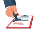 Red certified rubber stamp on a white sheet of paper. Stamp holding in hand. Royalty Free Stock Photo