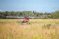 A red Cessna 150 takes off from the runway Royalty Free Stock Photo