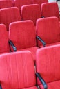 Red chair close-up. Rows seats in empty movie theater.