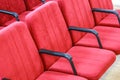 Red chair close-up. Rows seats in empty movie theater.