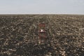 Red chair with a flowerpot stands among the empty field