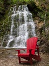 Red chair in front La Chute waterfall Royalty Free Stock Photo