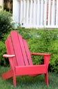 The red chair is on the front lawn in font of the porch. Royalty Free Stock Photo