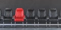 Red chair in a row of black chairs in an office. Business, leadership, recruiting and employment concept Royalty Free Stock Photo