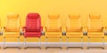 Red chair in a row of yellow chairs in an office. Business, leadership, recruiting and employment concept Royalty Free Stock Photo