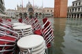red chairs of alfresco cafe with water in saint Mark square in V Royalty Free Stock Photo