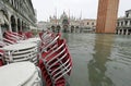 Red chairs of a sidewalk cafe in Saint Mark Square in Venice wit Royalty Free Stock Photo