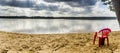 Red chear on lake beach