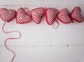 Red check hearts on rustic white wooden background
