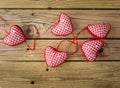 Red check hearts on rustic wooden background