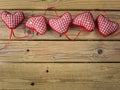 Red check hearts on rustic wooden background