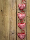 Red check hearts on rustic wooden background