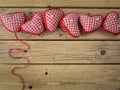 Red check hearts on rustic wooden background