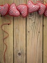 Red check hearts on rustic wooden background