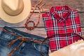 Red check shirt, jeans, leather hat, bag and belt