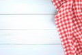 Red checked picnic towel cloth on blue wooden empty space background