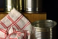 RED CHECKERED DISHCLOTH WITH EMPTY TIN CANS Royalty Free Stock Photo