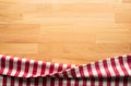 Red checkered fabric on wood table background.For decoration key visual Royalty Free Stock Photo