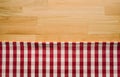 Red checkered fabric on wood table background.For decoration Royalty Free Stock Photo