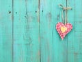 Red checkered and gold hearts handing on antique green wood door Royalty Free Stock Photo