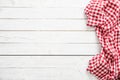 Red checkered kitchen tablecloth on wooden table Royalty Free Stock Photo