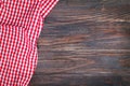 Red checkered napkin on a rustic wooden table with copy space Royalty Free Stock Photo