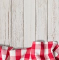 Red checkered picnic tablecloth on white wood table