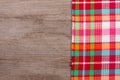 Red checkered tablecloth on an old wooden table with copy space for your text. Top view Royalty Free Stock Photo