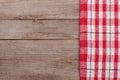 Red checkered tablecloth on an old wooden table with copy space for your text. Top view Royalty Free Stock Photo