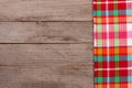 Red checkered tablecloth on an old wooden table with copy space for your text. Top view Royalty Free Stock Photo