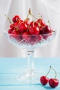 Red cherries in crystal vase