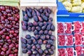 Red cherries, peaches, figs, bananas and raspberries in boxes for sale Royalty Free Stock Photo