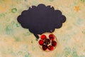 Red cherries in glass on rustic table and empty chalkboard. Overhead view, copy space.ripe sweet cherry and black board