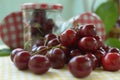 Red cherries with stems on yellow tablecloth Royalty Free Stock Photo